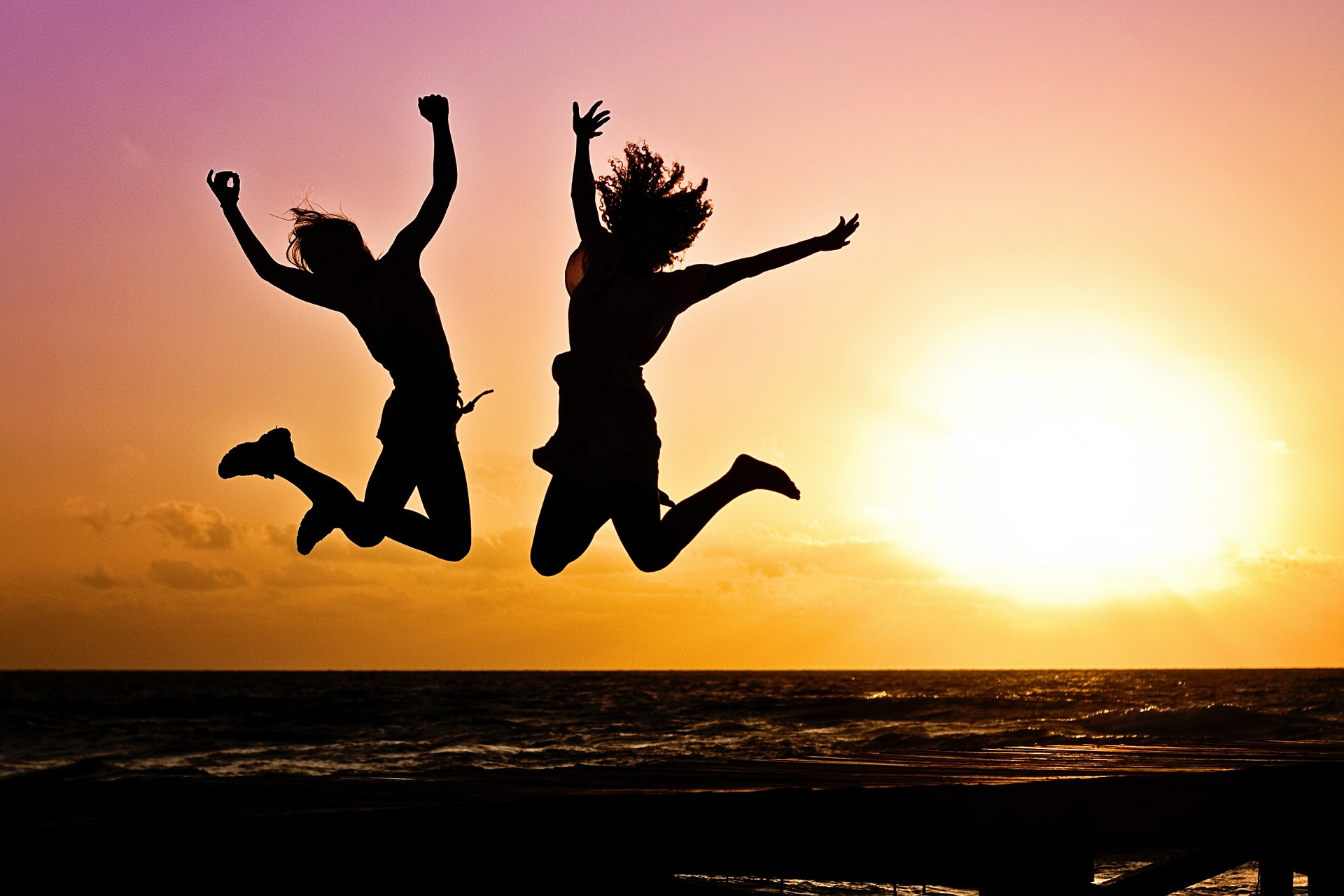 people jumping on beach