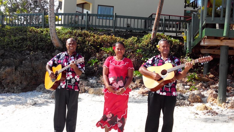 Friendly locals singing and playing guitar at Fiji island beach wedding
