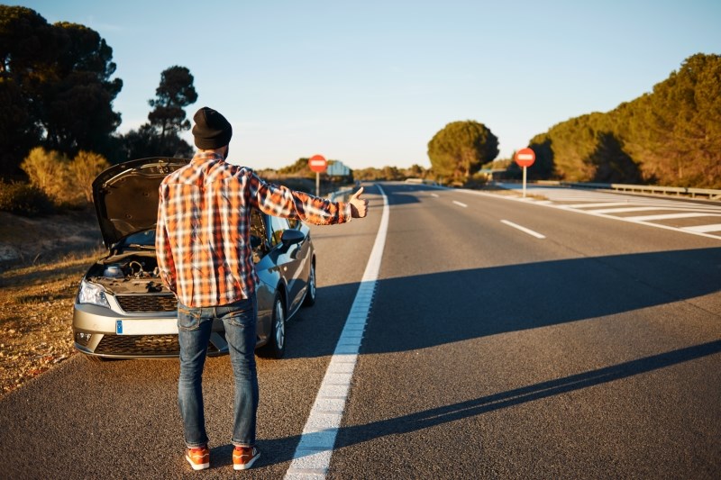 Male traveller stranded on highway after car breakdown