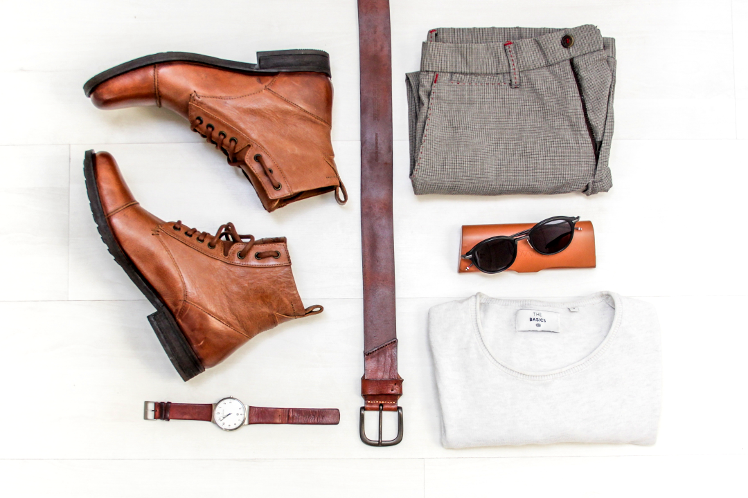 flatlay of mens shoes belt clothing accessories