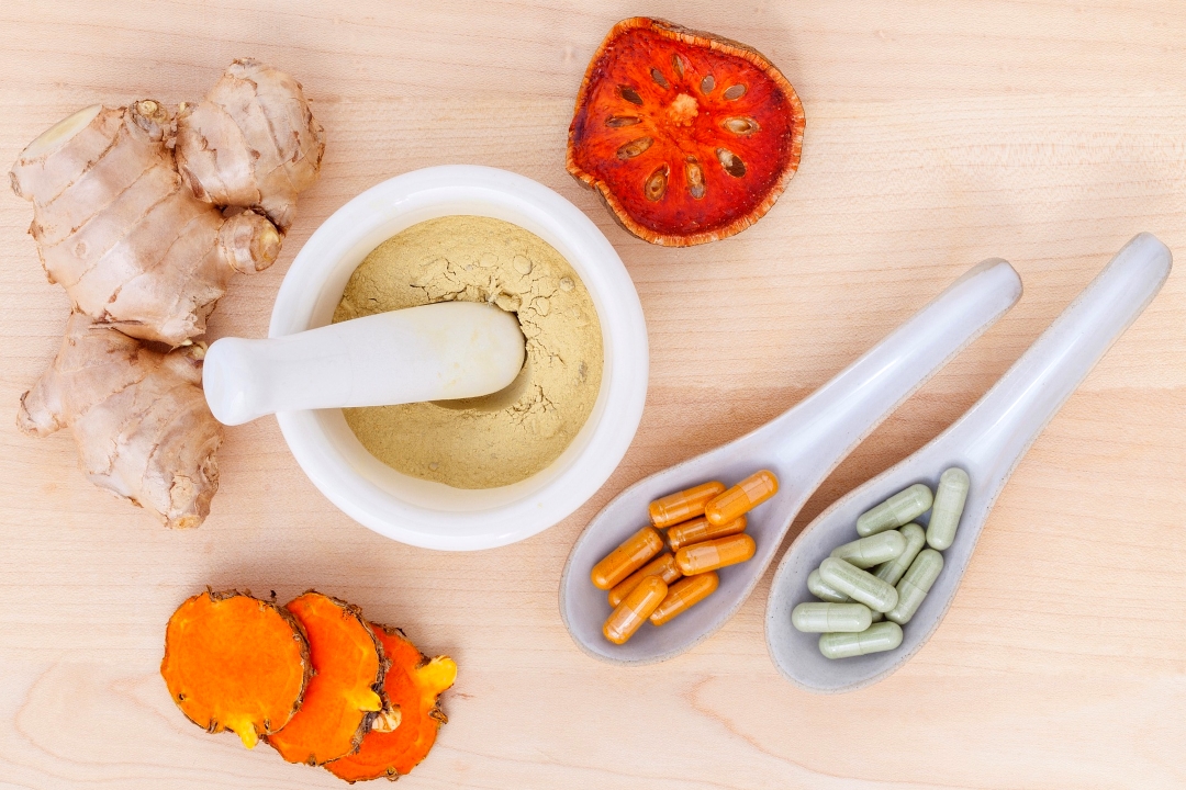 mortar and pestle with ground ginger and turmeric