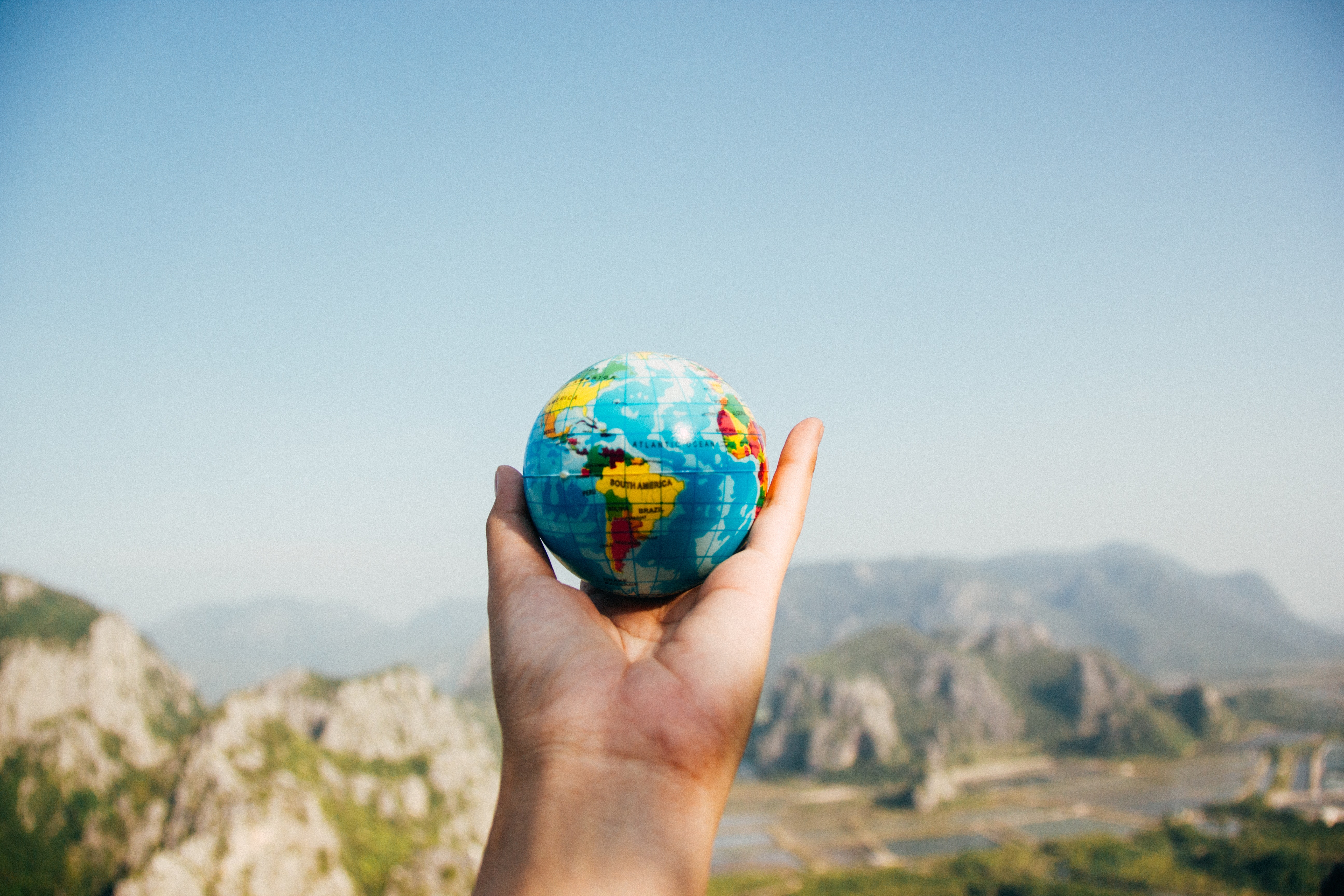 person holding globe