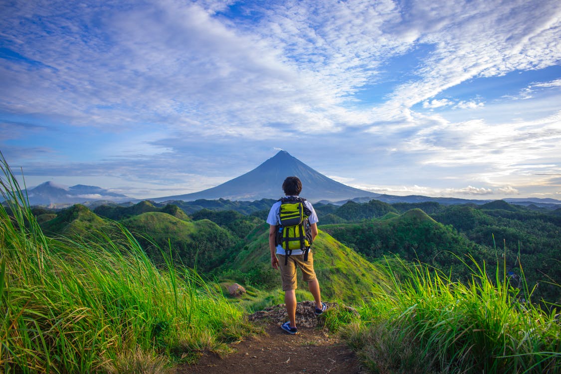 man hiking with a view of mountain