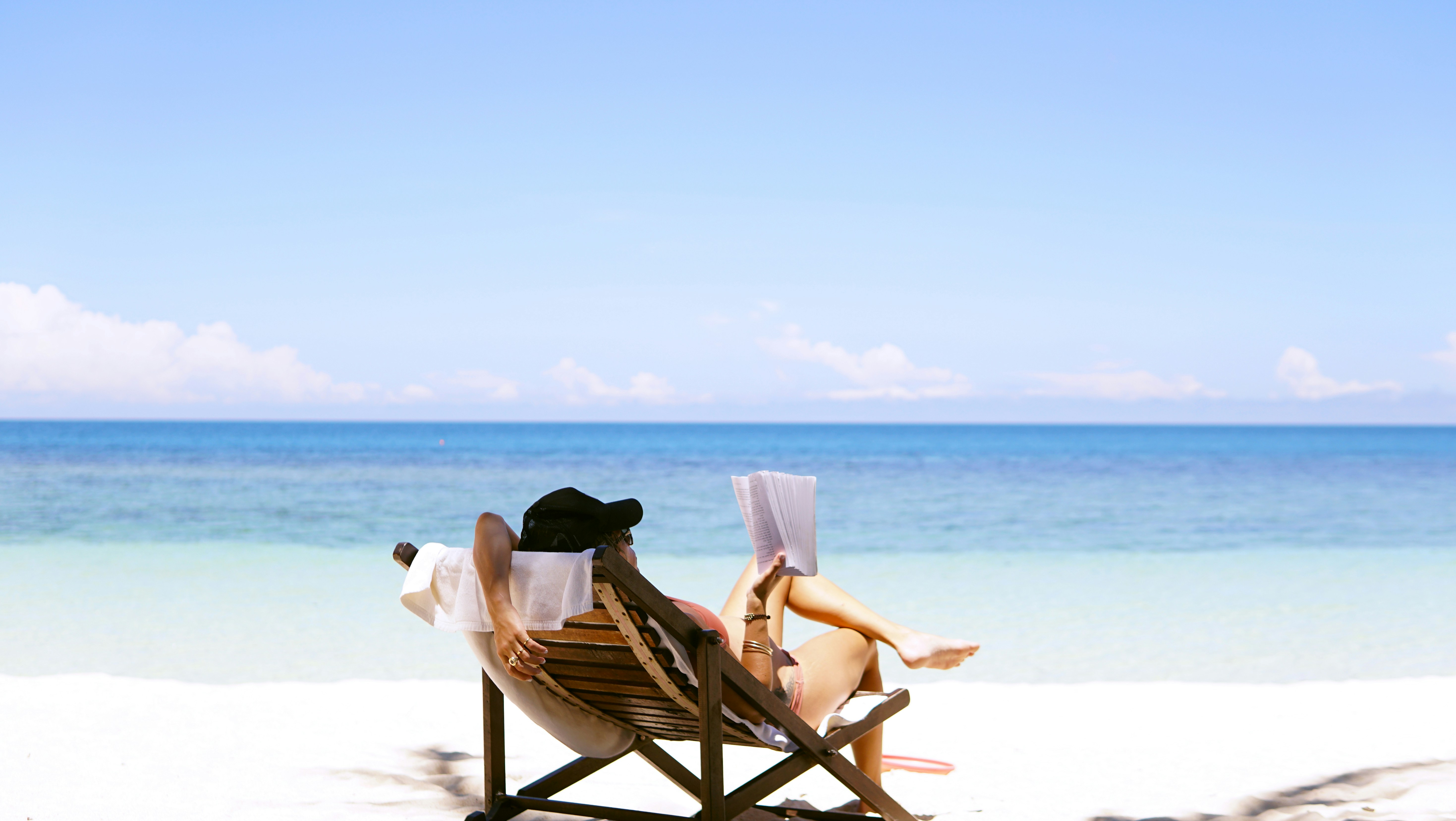 a person reading on the beach